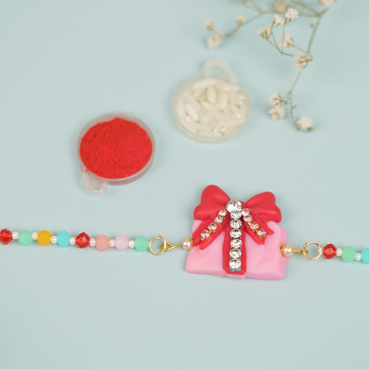 Handmade Beaded Gift Box Theme Clay Bracelet Rakhi With Roli Chawal For Sisters - Close-up of bracelet centerpiece