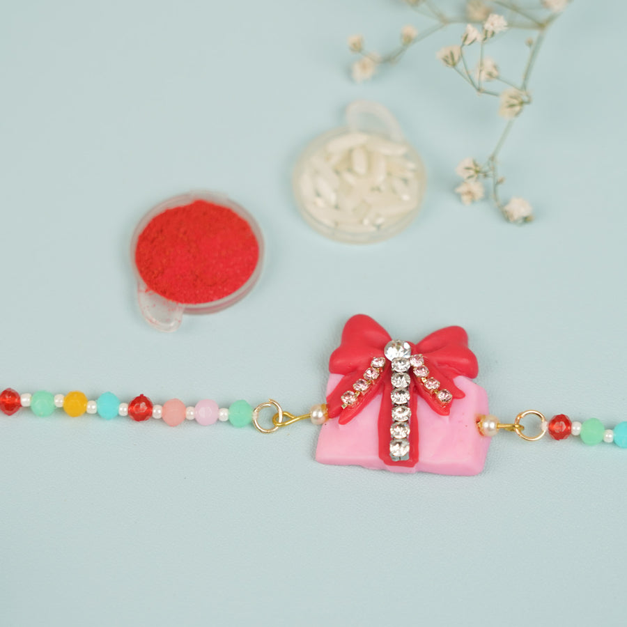Handmade Beaded Gift Box Theme Clay Bracelet Rakhi With Roli Chawal For Sisters - Close-up of bracelet centerpiece