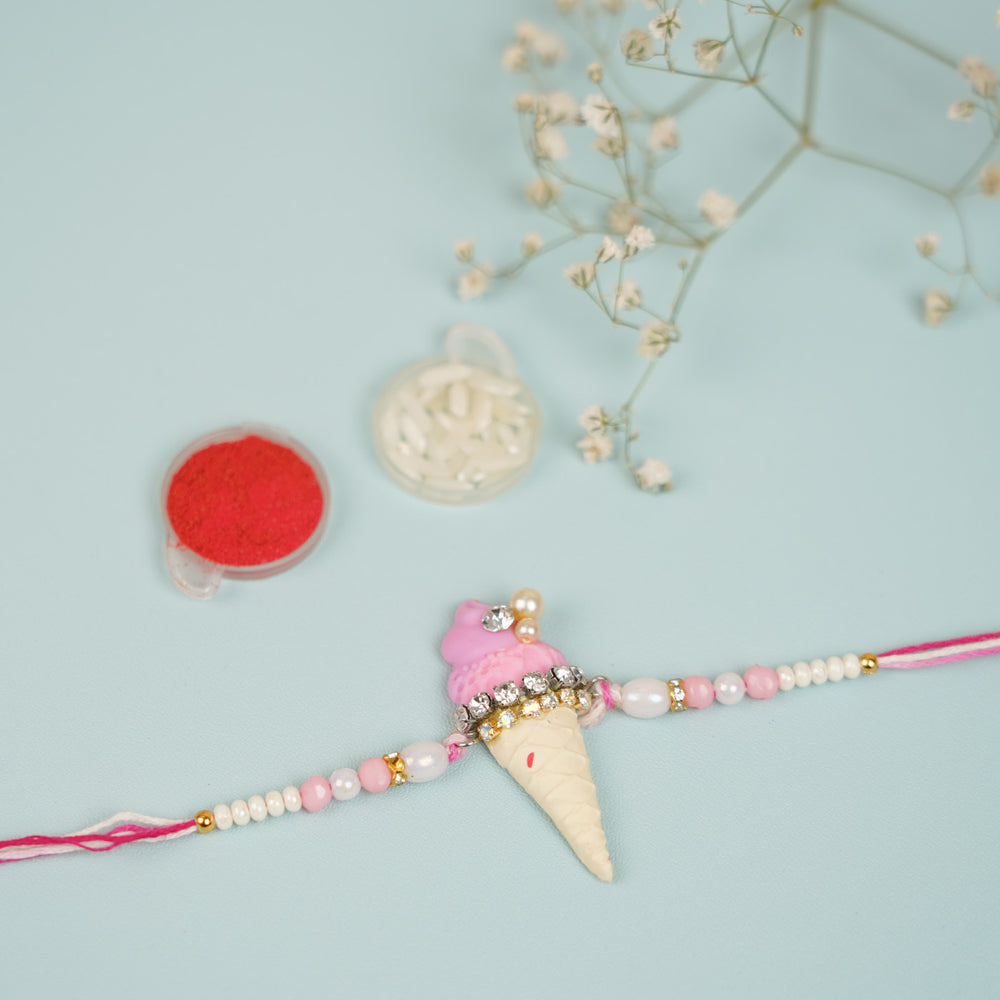 Handmade Beaded Icecream Theme Clay Rakhi With Roli Chawal For Sisters - Flat Lay with Accessories