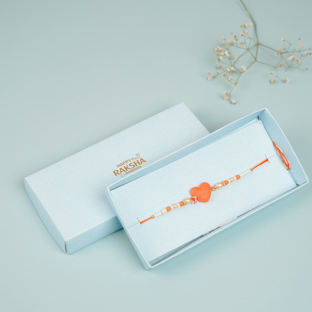 Handmade Beaded Orange Heart Shaped Clay Rakhi With Roli Chawal - Rakhi in gift box packaging