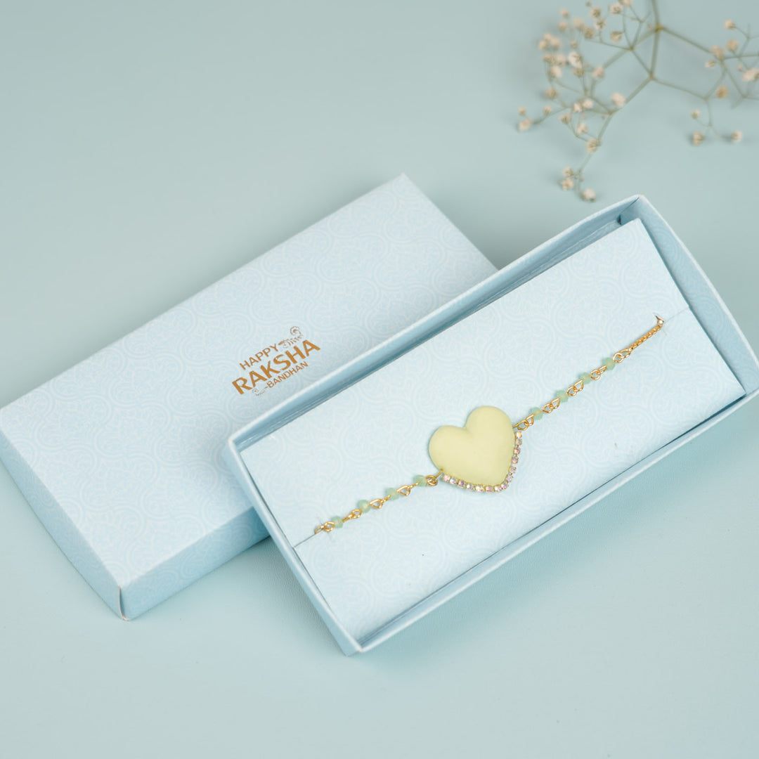 Handmade Beaded Yellow Heart Shaped Clay Bracelet Rakhi With Roli Chawal For Sisters - In Packaging with Brand Logo