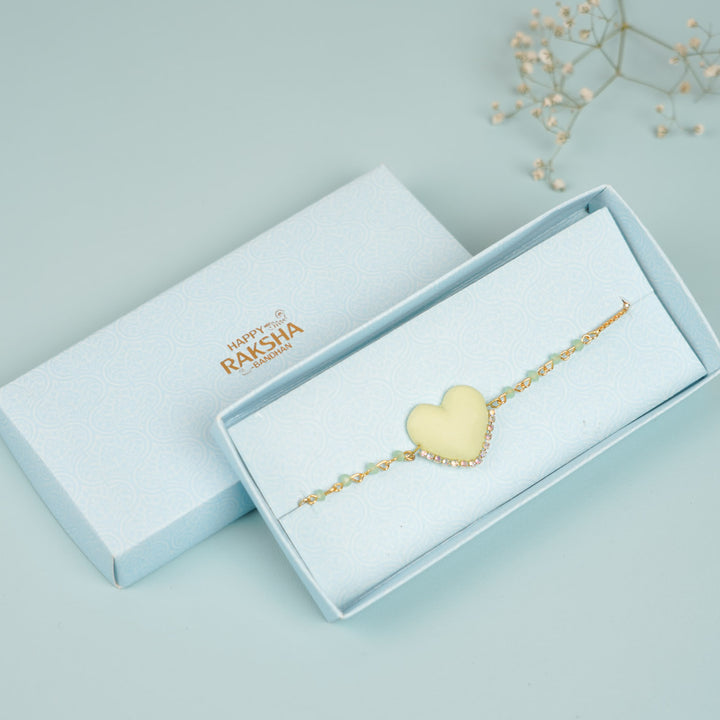 Handmade Beaded Yellow Heart Shaped Clay Bracelet Rakhi With Roli Chawal For Sisters - In Packaging with Brand Logo