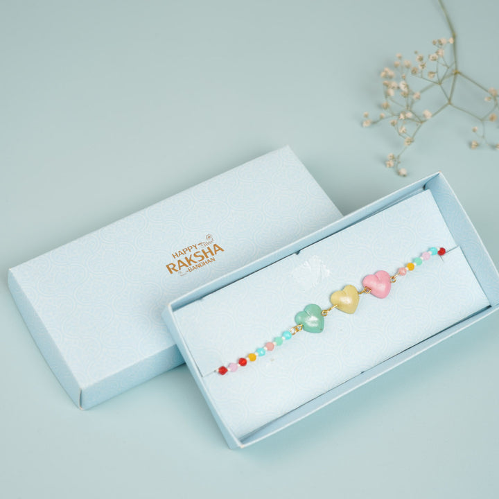 Handmade Beaded Multicolour Hearts Clay Bracelet Rakhi With Roli Chawal For Sisters - Bracelet in gift box packaging
