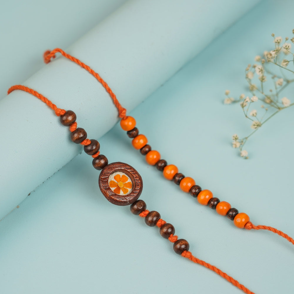 Handmade Pressed Flower Art Kesari Beaded Wooden Bhaiya Bhabhi Rakhi With Roli Chawal - Close-Up of Single Bracelet