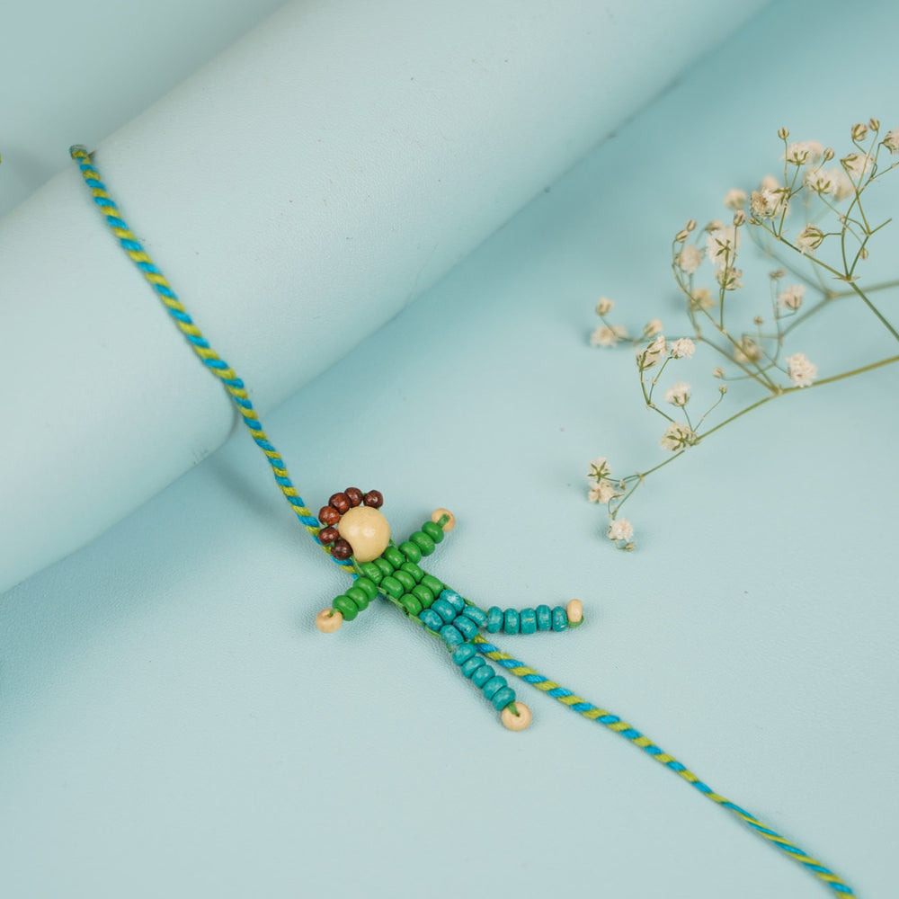 Handmade Beaded Blue Disco Boy Wooden Rakhi With Roli Chawal For Kids - Close-up of Rakhi Detail