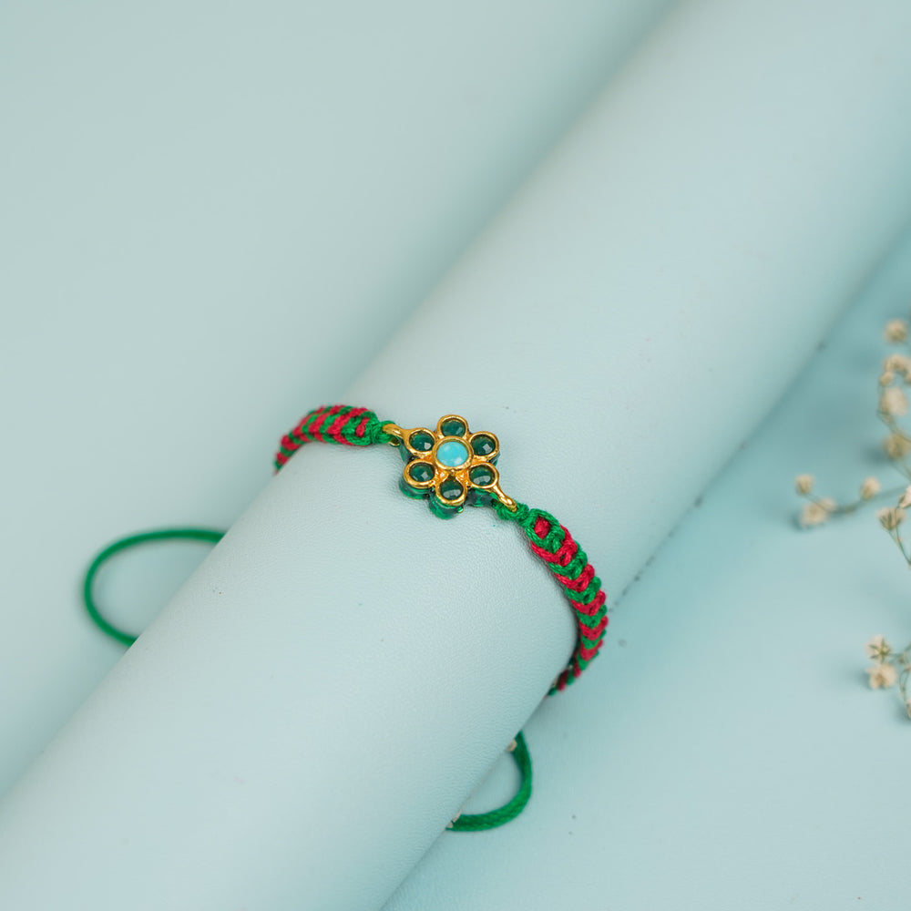 Handmade Floral Design Metal Rakhi For Brother - Close-up on Rolled Display