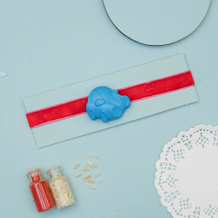 Handmade Car Crayon Kids Rakhi With Roli Chawal - Styled product with packaging and props