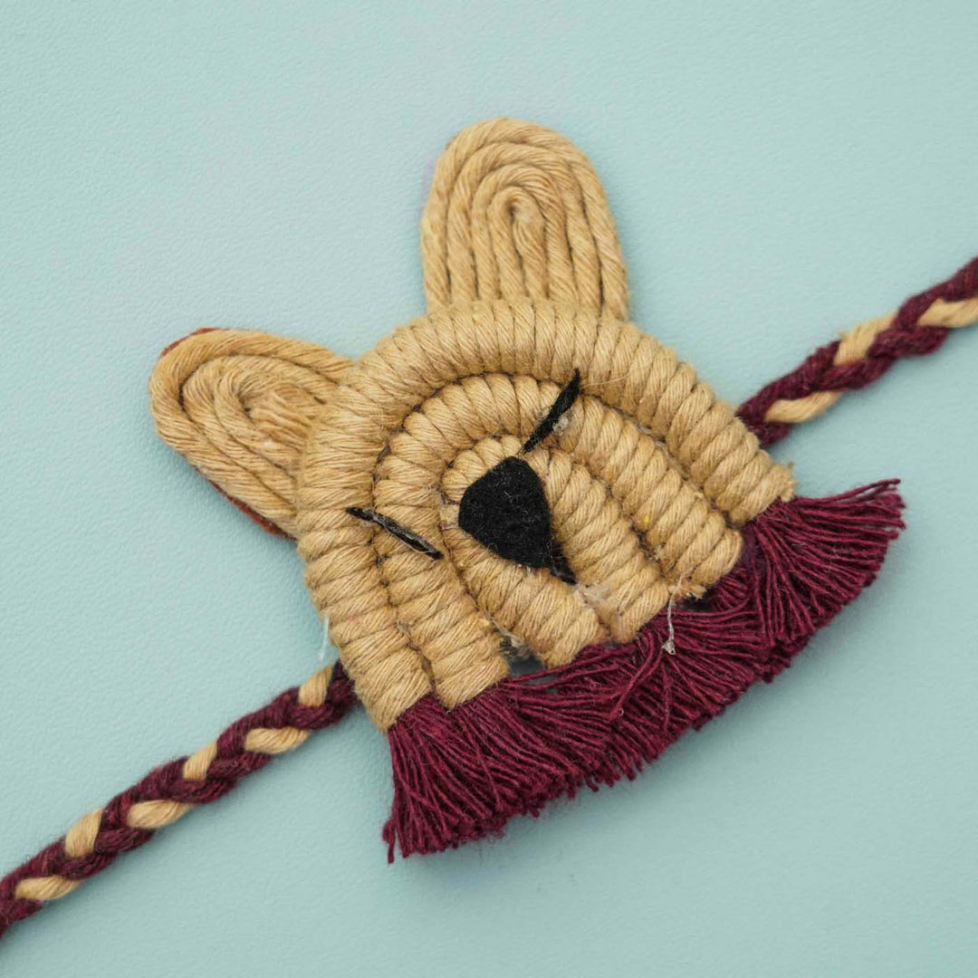 Handmade Macrame Brown Lion Design Cotton Kids Rakhi With Chocolates And Roli Chawal - Close-up of single braided band