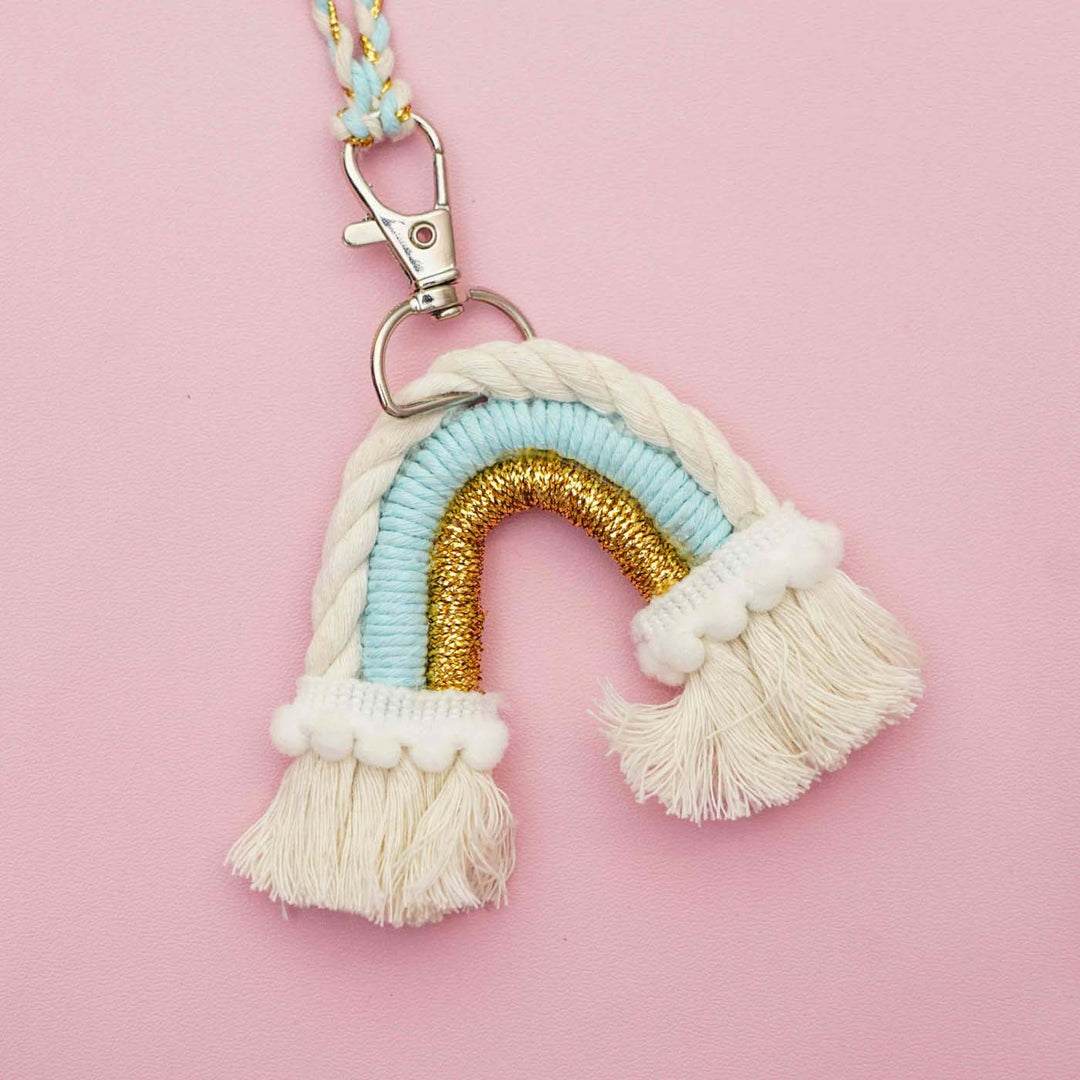 Handmade Macrame Rainbow Theme Cotton Kids Rakhi For Girls With Chocolates And Roli Chawal - Close-up with clip attachment