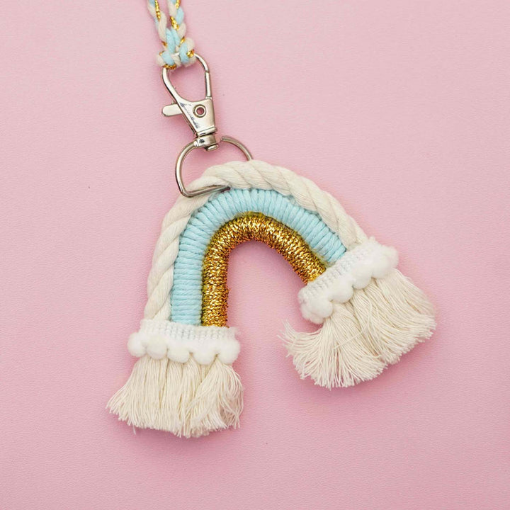 Handmade Macrame Rainbow Theme Cotton Kids Rakhi For Girls With Chocolates And Roli Chawal - Close-up with clip attachment