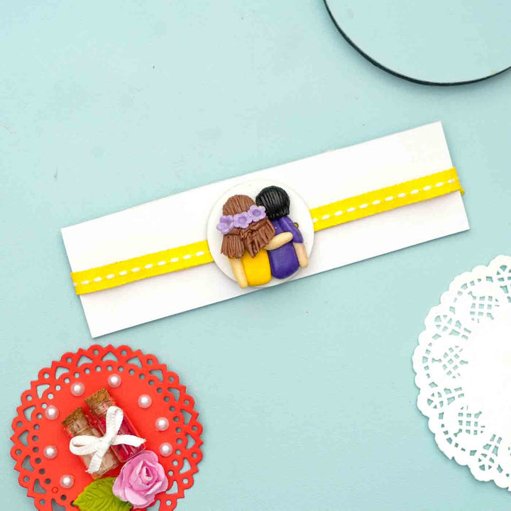 Reusable Miniature Clay X Large Rakhi With Roli Chawal - Flat Lay of Decorated Envelope