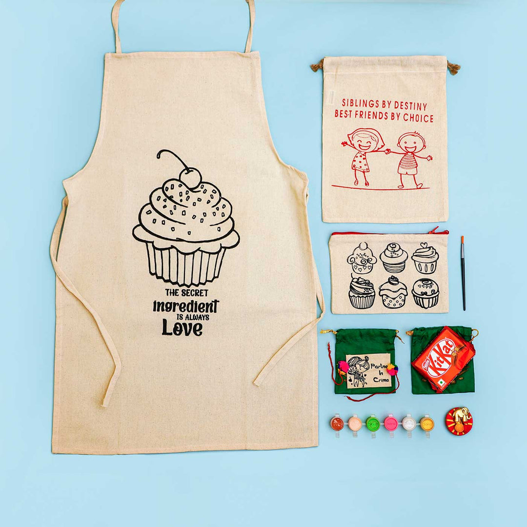 Eco Friendly Fabric Painting Diy Rakhi Hamper With Rice Roli 4 - Flat Lay of Cupcake Apron and Accessories