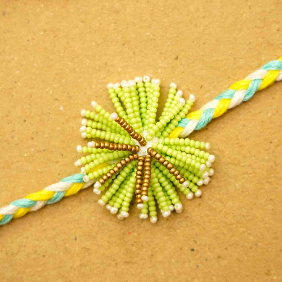 Reusable Beaded Green Flower Rakhi With Roli Chawal - Close-up of center bead detail