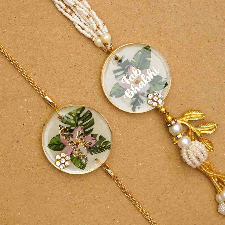 Handmade Resin Fab Bhaiya And Fab Bhabhi Flower Print Rakhi With Chocolates And Roli Chawal Set Of 2 - Close-up of two bracelets