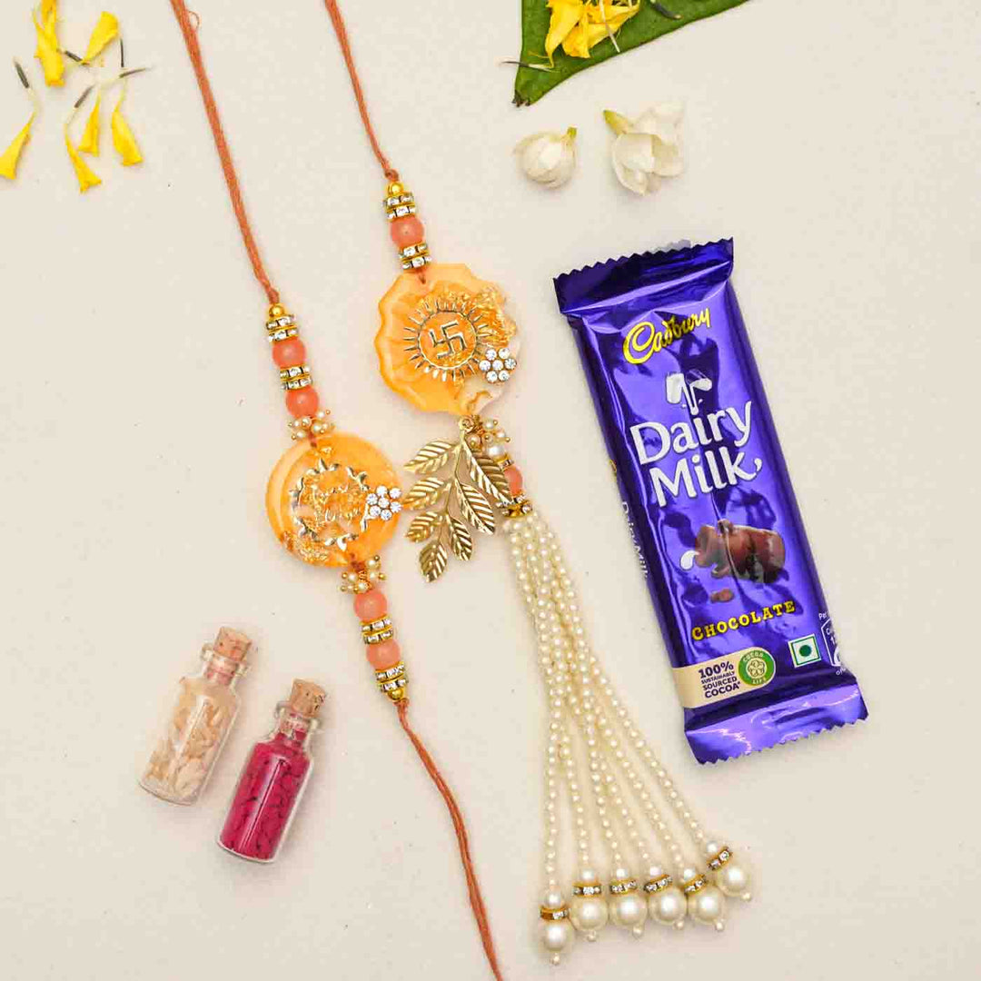 Handmade Resin Rakhi With Chocolates And Roli Chawal Set Of 2 - Rakhis with gift items flat lay