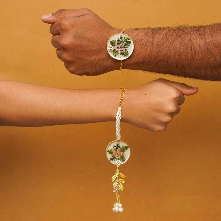 Handmade Resin Fab Bhaiya And Fab Bhabhi Flower Print Rakhi With Chocolates And Roli Chawal Set Of 2 - Two wrists wearing bracelets