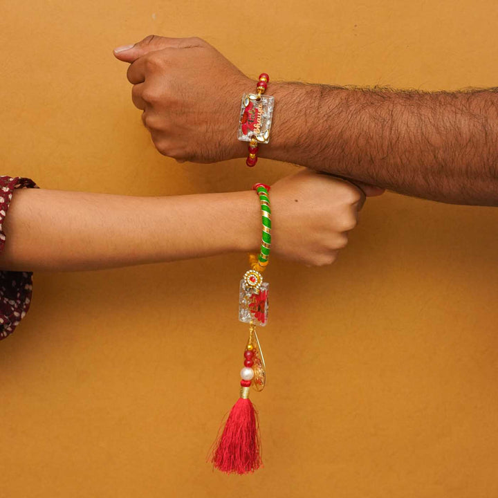 Handmade Resin Fab Bhaiya And Fab Bhabhi Rakhi With Chocolates And Roli Chawal Set Of 2 - Rakhi worn on wrists