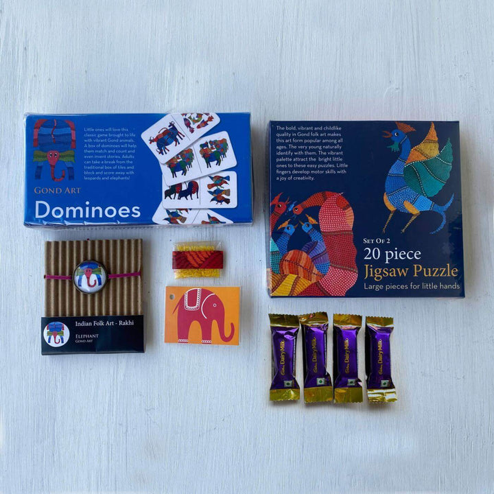 Handcrafted Folk Art Rakhi Hamper For Kids With Rice Roli Haldi 2 - Contents flat lay