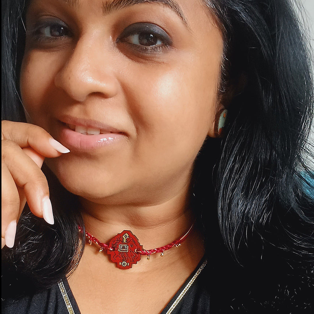 Handmade Red Elephant Ghungroo And Shell Wooden Bhaiya Bhabhi Rakhi With Roli Chawal - Model Wearing Bracelet Close-up