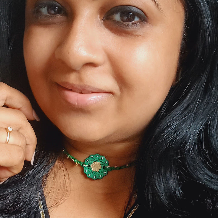 Handmade Green Ghungroo Shell And Beads Wooden Lumba Rakhi For Bhabhi With Roli Chawal - Model wearing product close-up