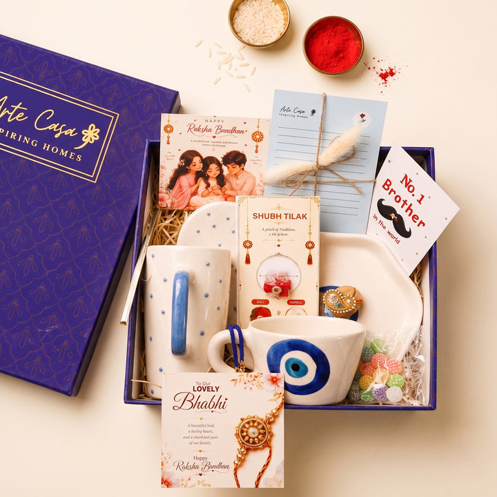 "Nazar Se Surakshit" Evil Eye Ceramic Rakhi Hamper With Mug, Sipper & Roli Chawal For Brother