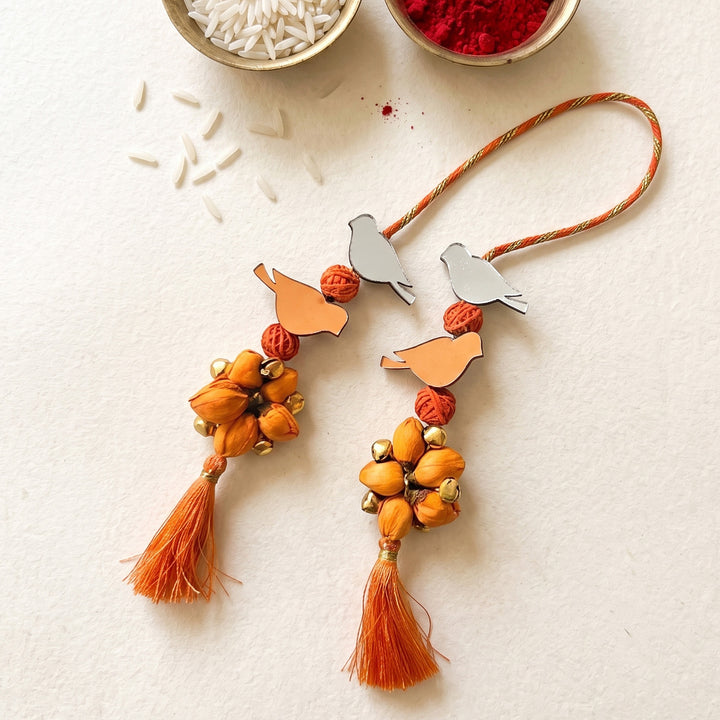 Handcrafted Bird Motif Shola Beaded Tassel Lumba Rakhi for Bhabhi - Orange