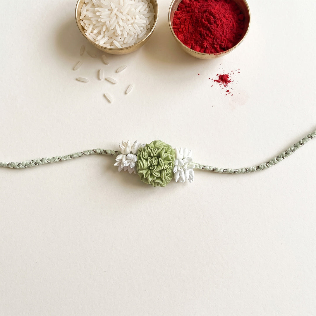 Handcrafted Rose & Mogra Bud Silk Fabric Floral Rakhi For Brother With Roli Chawal