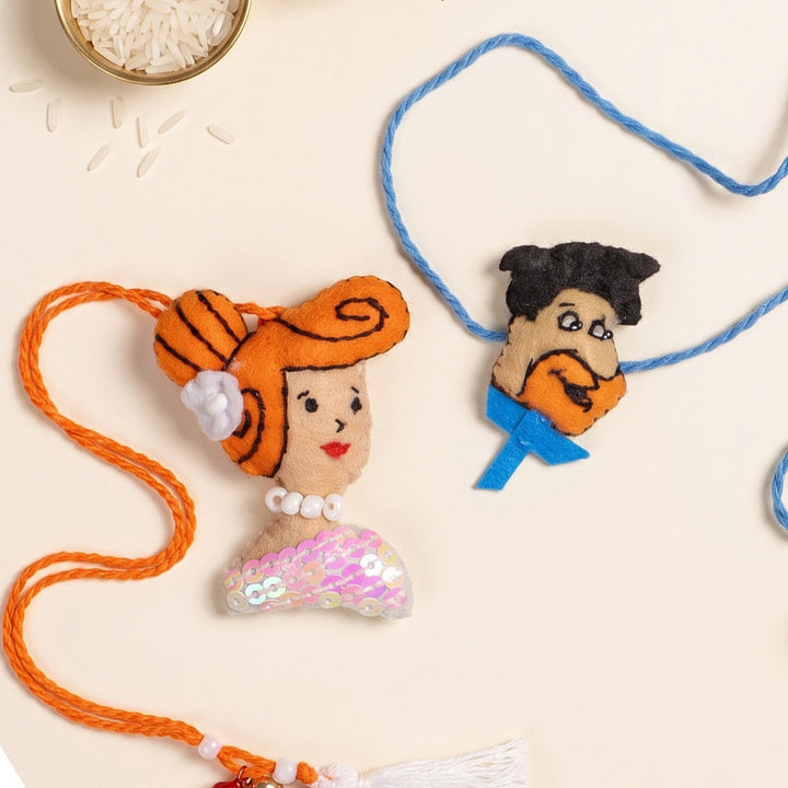 Hand Embroidered Fred & Wilma Couple Rakhi Lumba Set With Brooch Pin, Keychain & Magnet For Bhaiya Bhabhi