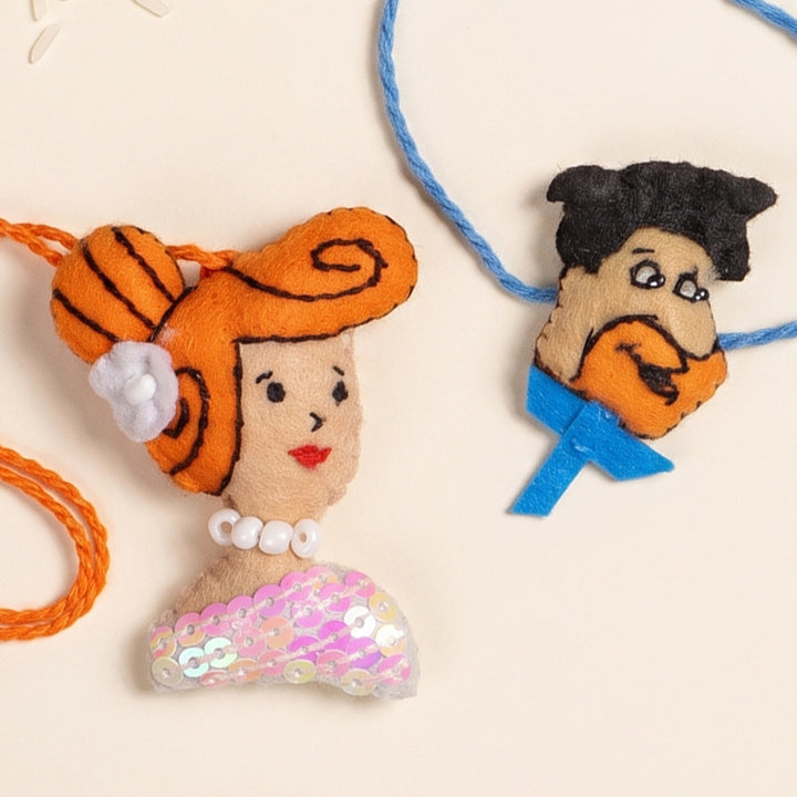Hand Embroidered Fred & Wilma Couple Rakhi Lumba Set With Brooch Pin, Keychain & Magnet For Bhaiya Bhabhi