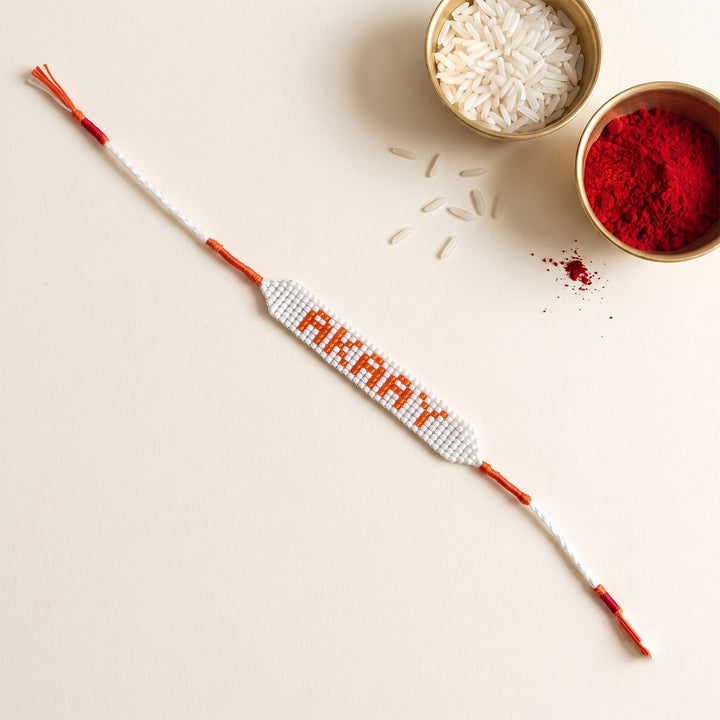 Personalized Hand Beaded White Base Bracelet Rakhi With Roli Chawal For Brother
