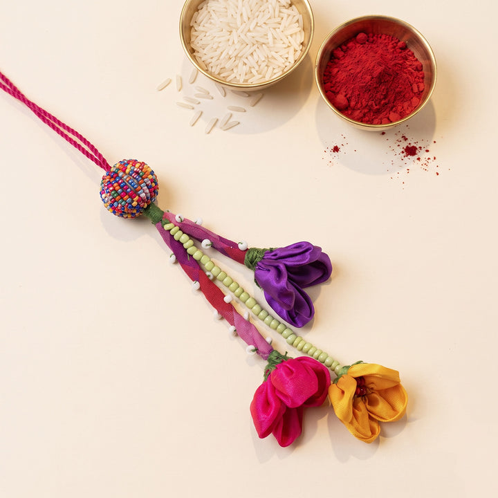 Multicoloured Fabric Flower Lumba Rakhi With Roli Chawal For Sister/Bhabhi