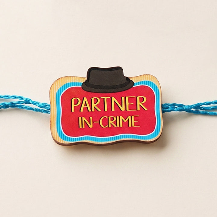 Glossy Printed Wooden 'Partner In Crime' Rakhi With Kumkum Rice For Brother