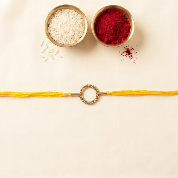 Handcrafted Circle Of Life Brass Rakhi With Roli Chawal For Brother