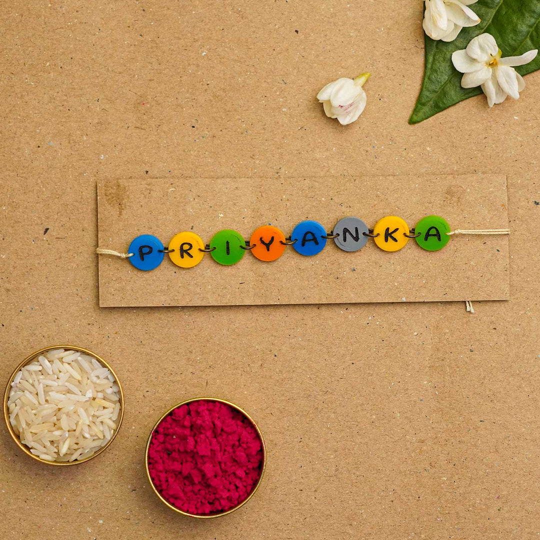 Personalized Handmade Gems Acrylic Rakhi With Roli Chawal - Name bead bracelet with rice and flowers