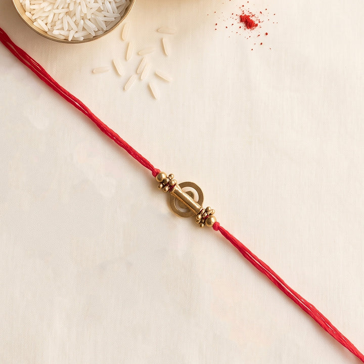 Beaded Shield & Bloom Brass Rakhi For Brother