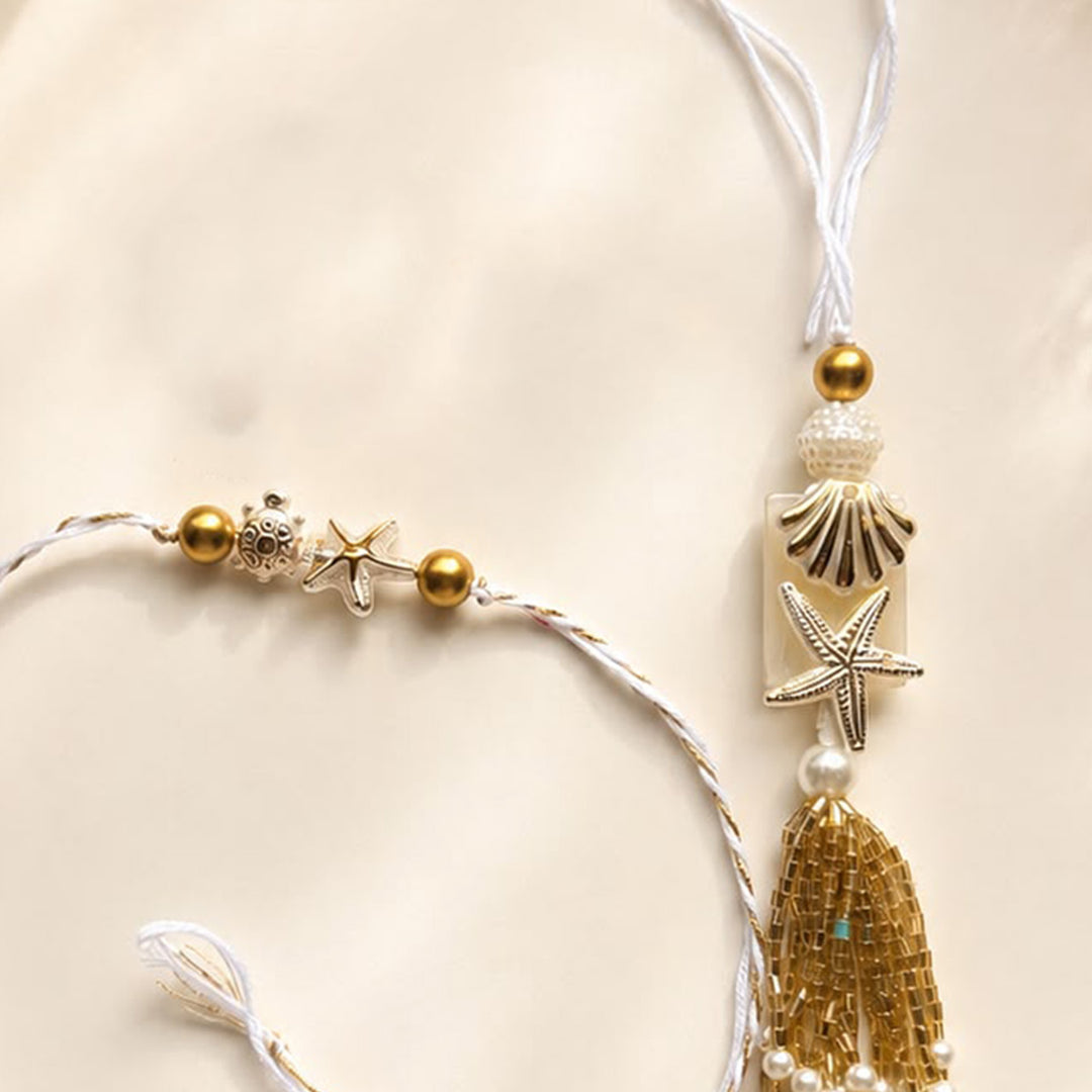Handmade Sea Shell Charm Moti Bead & Thread Rakhi With Lumba With Roli Chawal For Bhaiya Bhabhi | Set Of 2