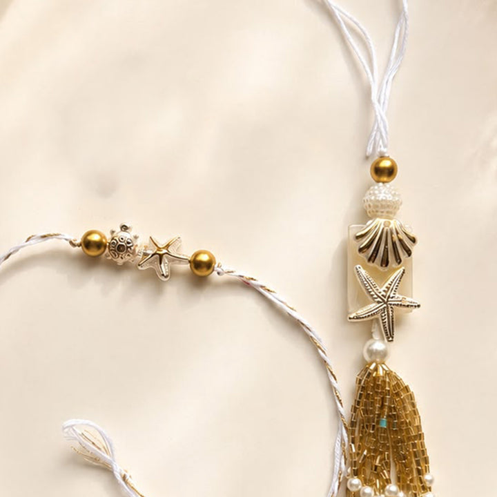 Handmade Sea Shell Charm Moti Bead & Thread Rakhi With Lumba With Roli Chawal For Bhaiya Bhabhi | Set Of 2