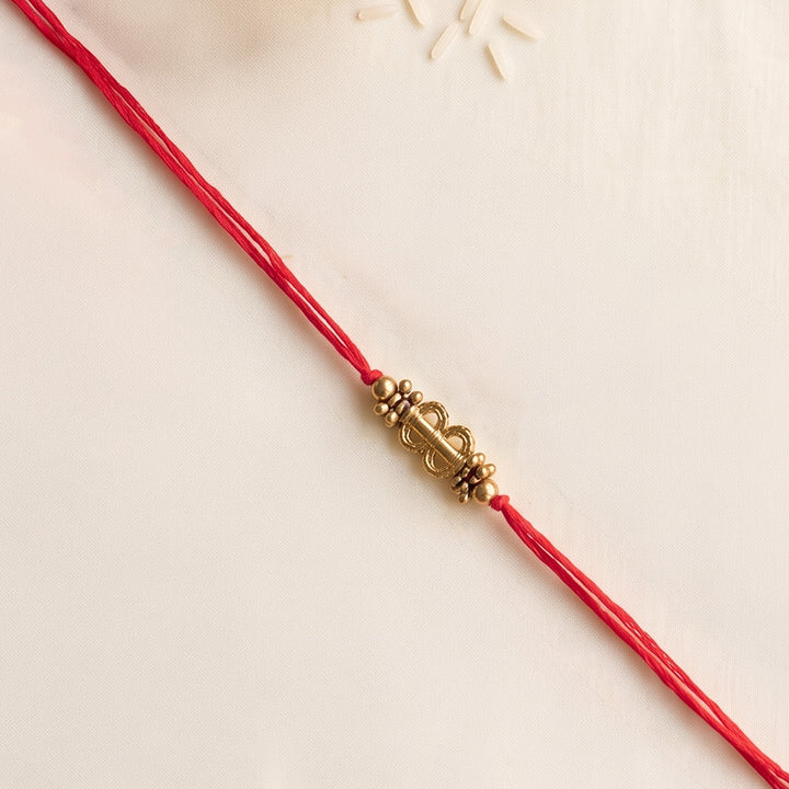 Beaded Shield & Bloom Brass Rakhi For Brother