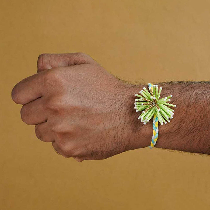 Reusable Beaded Green Flower Rakhi With Roli Chawal - Model wearing on wrist