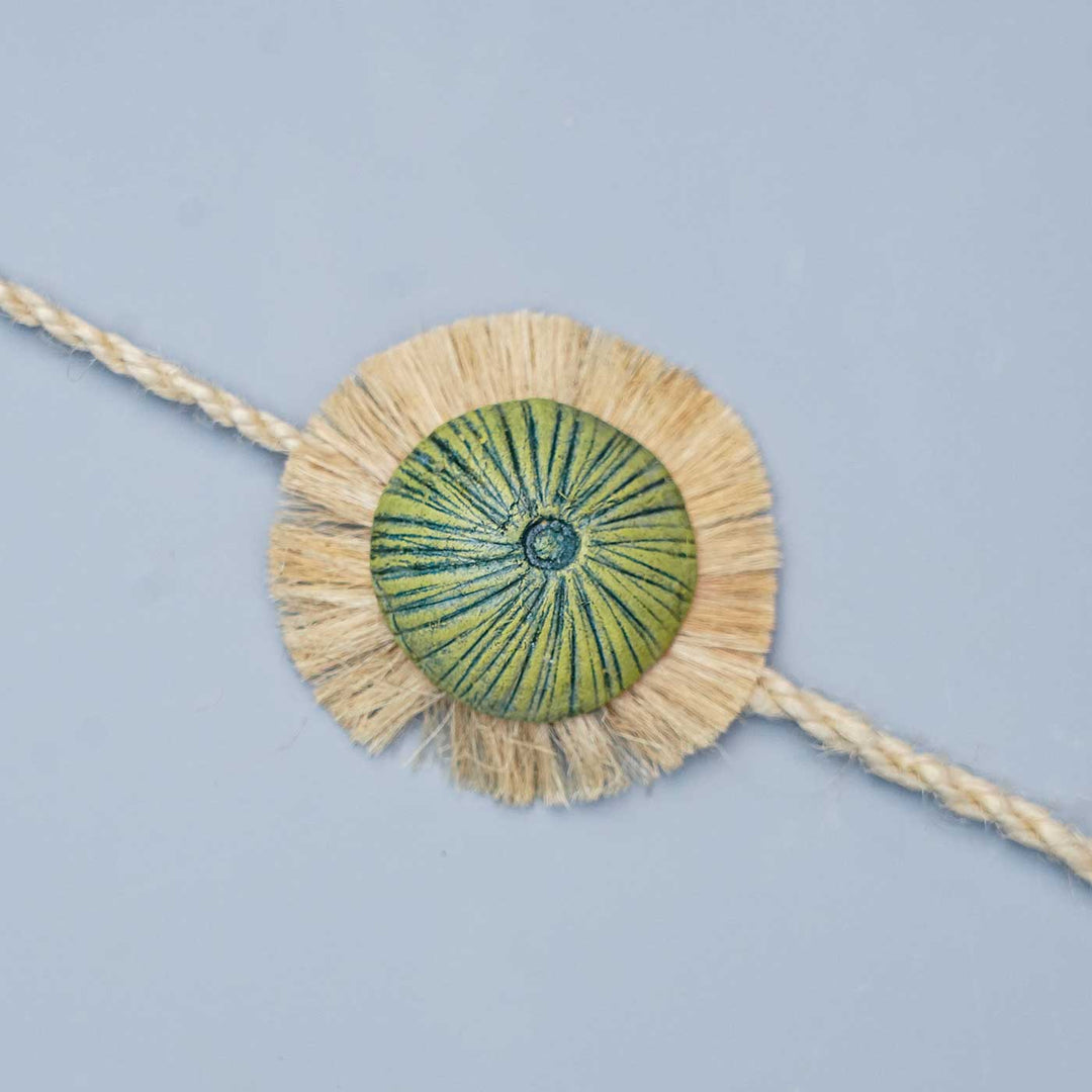 Handmade Papier Mache Green With Rustic Flower Rakhi With Roli Chawal - Close-up of Bracelet Detail
