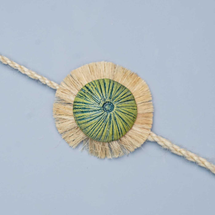 Handmade Papier Mache Green With Rustic Flower Rakhi With Roli Chawal - Close-up of Bracelet Detail
