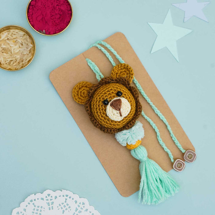 Handmade Crochet Lion Cub Kids Rakhi With Roli Chawal - Close-up with Tassel Detail