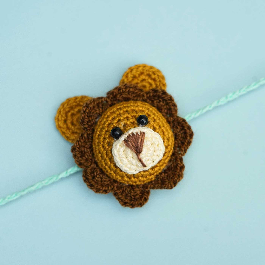Handmade Crochet Lion Cub Kids Rakhi With Roli Chawal - Close-up Front View