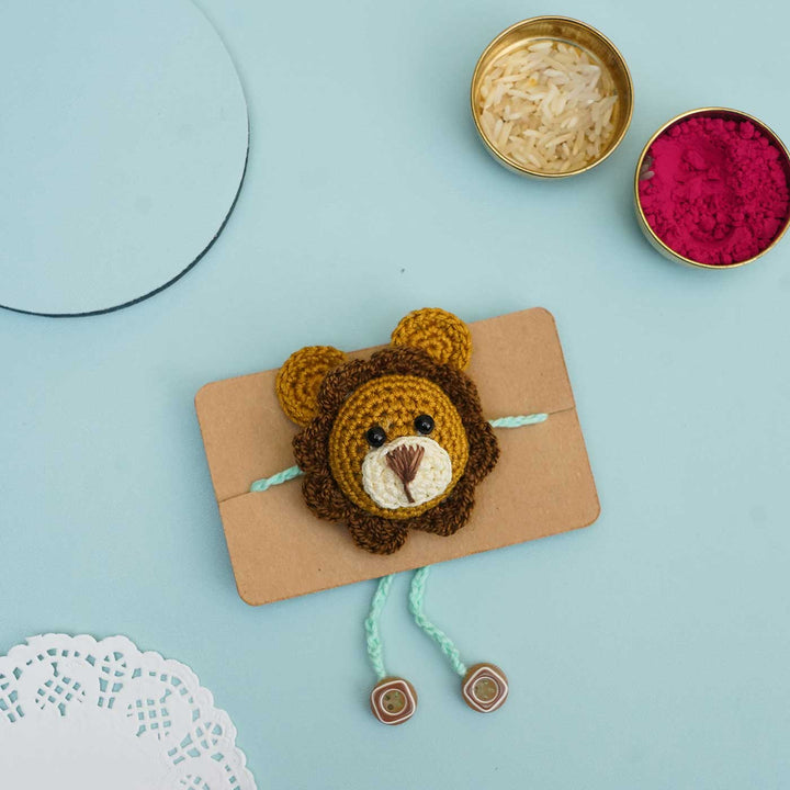 Handmade Crochet Lion Cub Kids Rakhi With Roli Chawal - Front View on Display Card