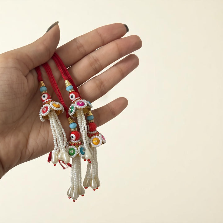 Handmade Red Evil Eye Lumba Rakhi For Bhabhi With Roli Chawal - Held in Hand Showing Size
