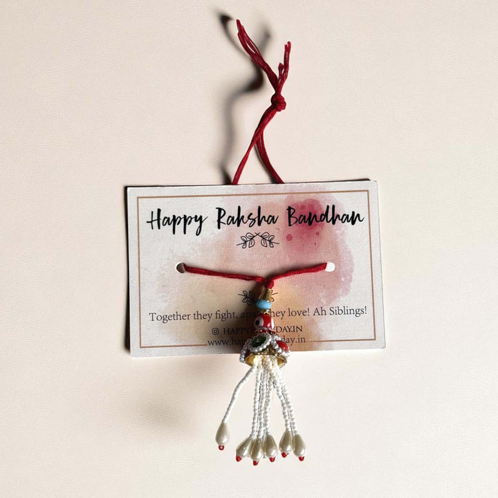 Handmade Red Evil Eye Lumba Rakhi For Bhabhi With Roli Chawal - Product on Branded Card