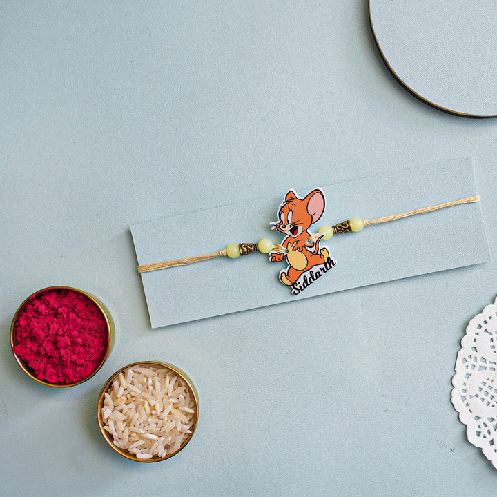 Personalized Handmade Tom And Jerry Acrylic Kids Rakhi With Roli Chawal - Flat Lay with Rakhi and Puja Items (4)
