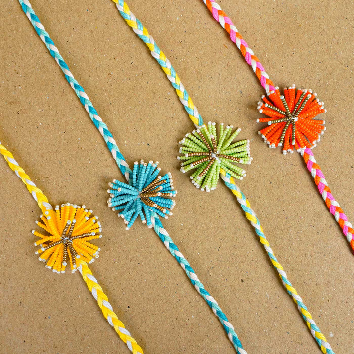Reusable Beaded Orange Flower Rakhi With Roli Chawal - Four Bracelets Side by Side