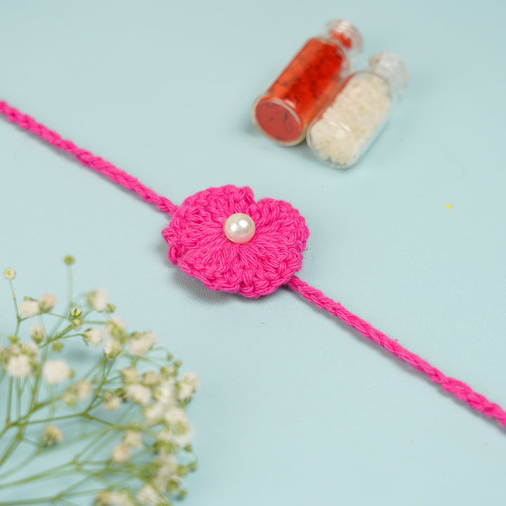 Handmade Crochet Scarlet Knot Bhaiya Bhabhi Rakhi With Roli Chawal - Flower on braided string flat lay
