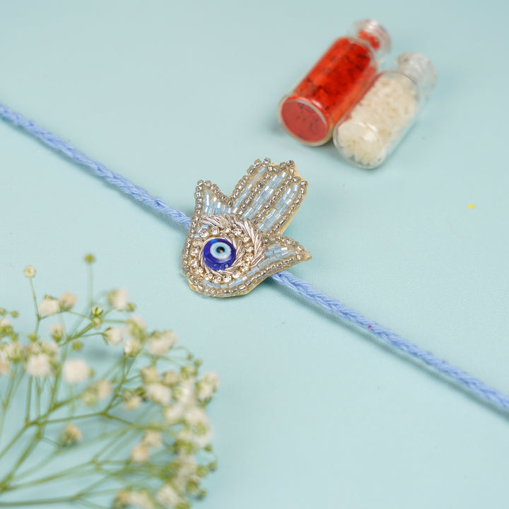 Handmade Beaded Evil Eye Hamsa Hand Rakhi With Roli Chawal - Charm with Roli and Chawal Bottles